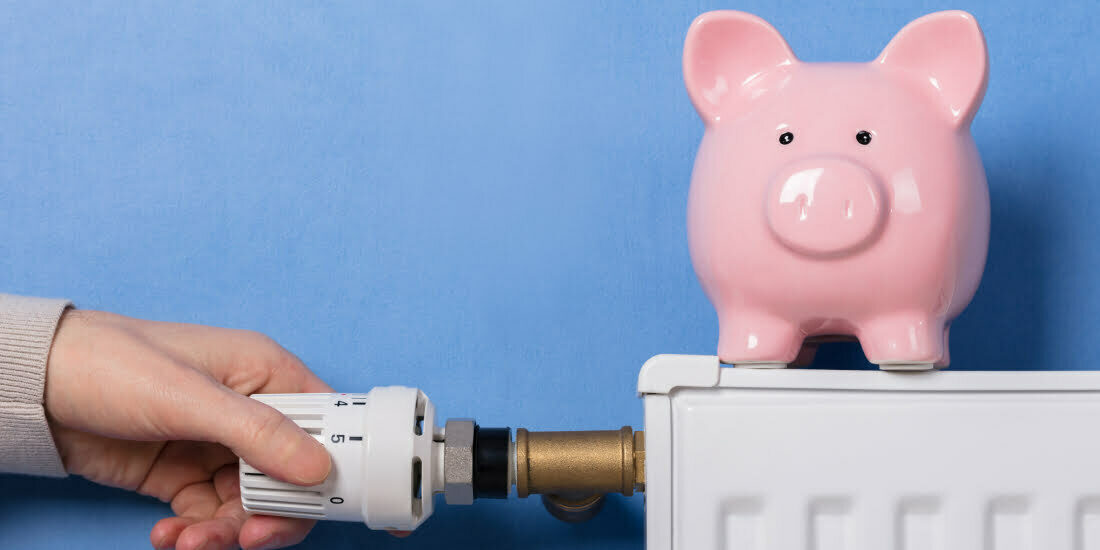 Piggy bank on radiator with thermostat